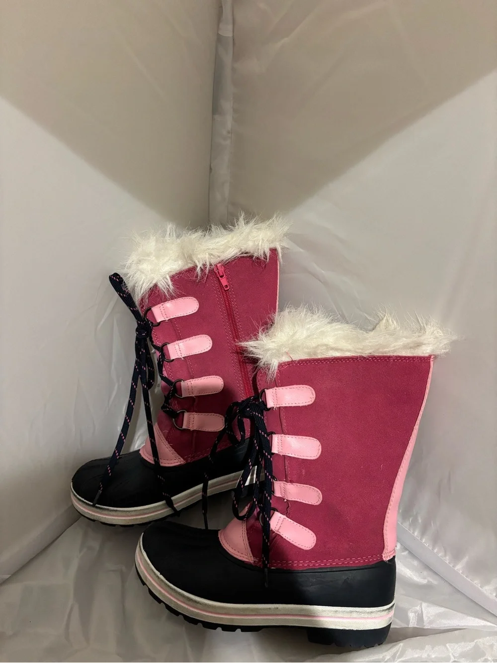 The image shows the black rubber lug outsole of an Ozark Trail kids' winter boot